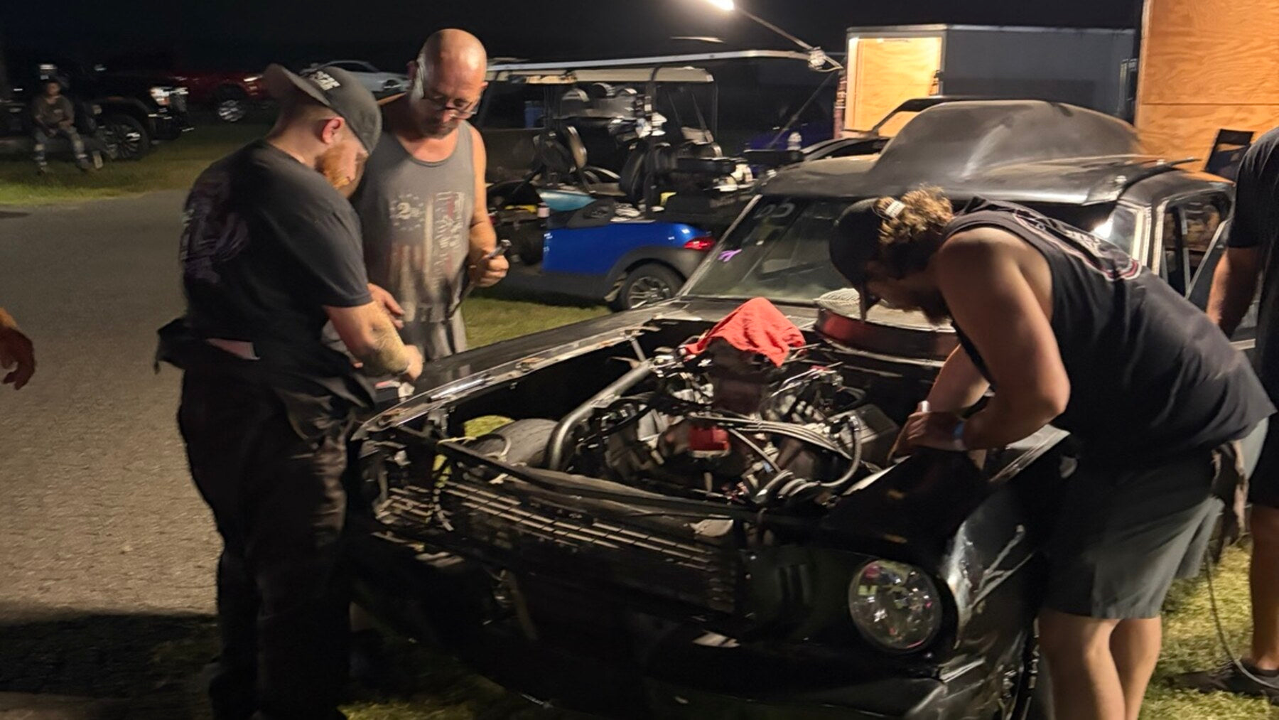Crew working on a race car between passes in the pits