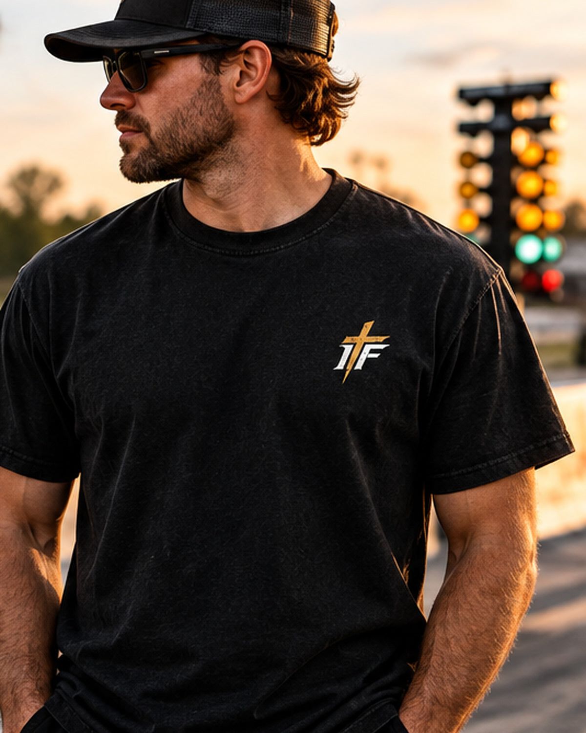 Man in sunglasses wearing Clean 660 Tee front with gold IFR chest logo at the strip