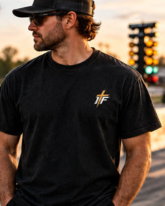 Man in sunglasses wearing Clean 660 Tee front with gold IFR chest logo at the strip