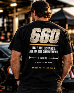 Man in Clean 660 Tee standing beside a car in the pits