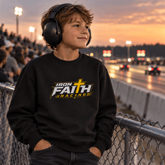 Boy in Iron Faith Racing youth crewneck and ear protection at the strip at sunset