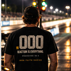 Man in Reaction .000 Tee facing the starting line lights at night