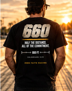 Man in Clean 660 Tee facing the drag strip at sunset