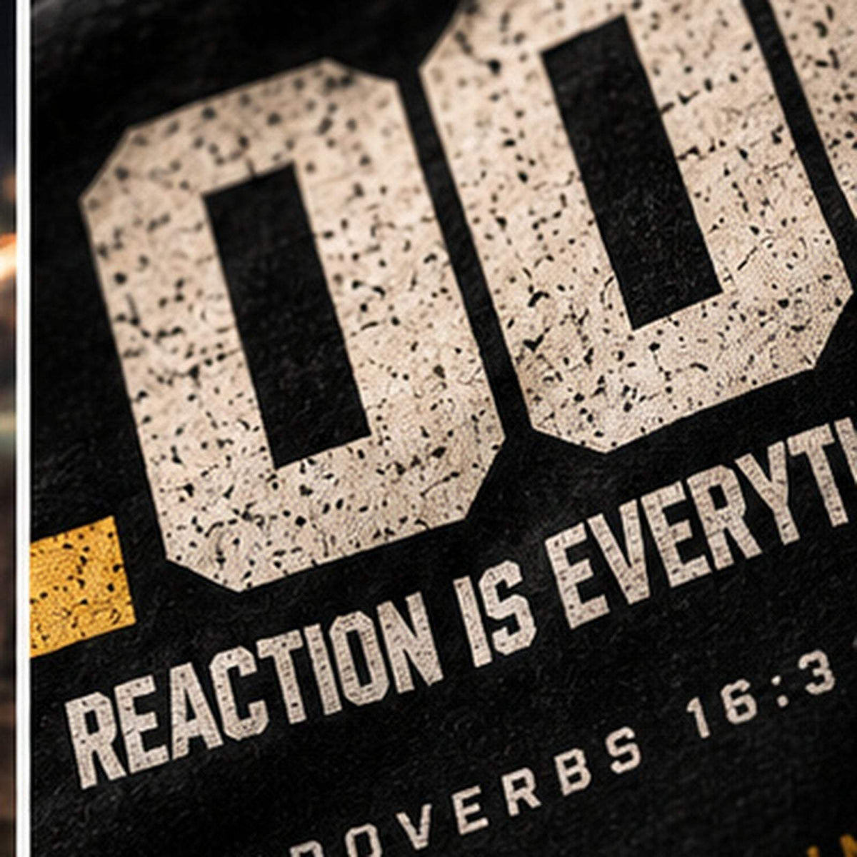 Close-up of distressed .000 Reaction Is Everything lettering on the back print