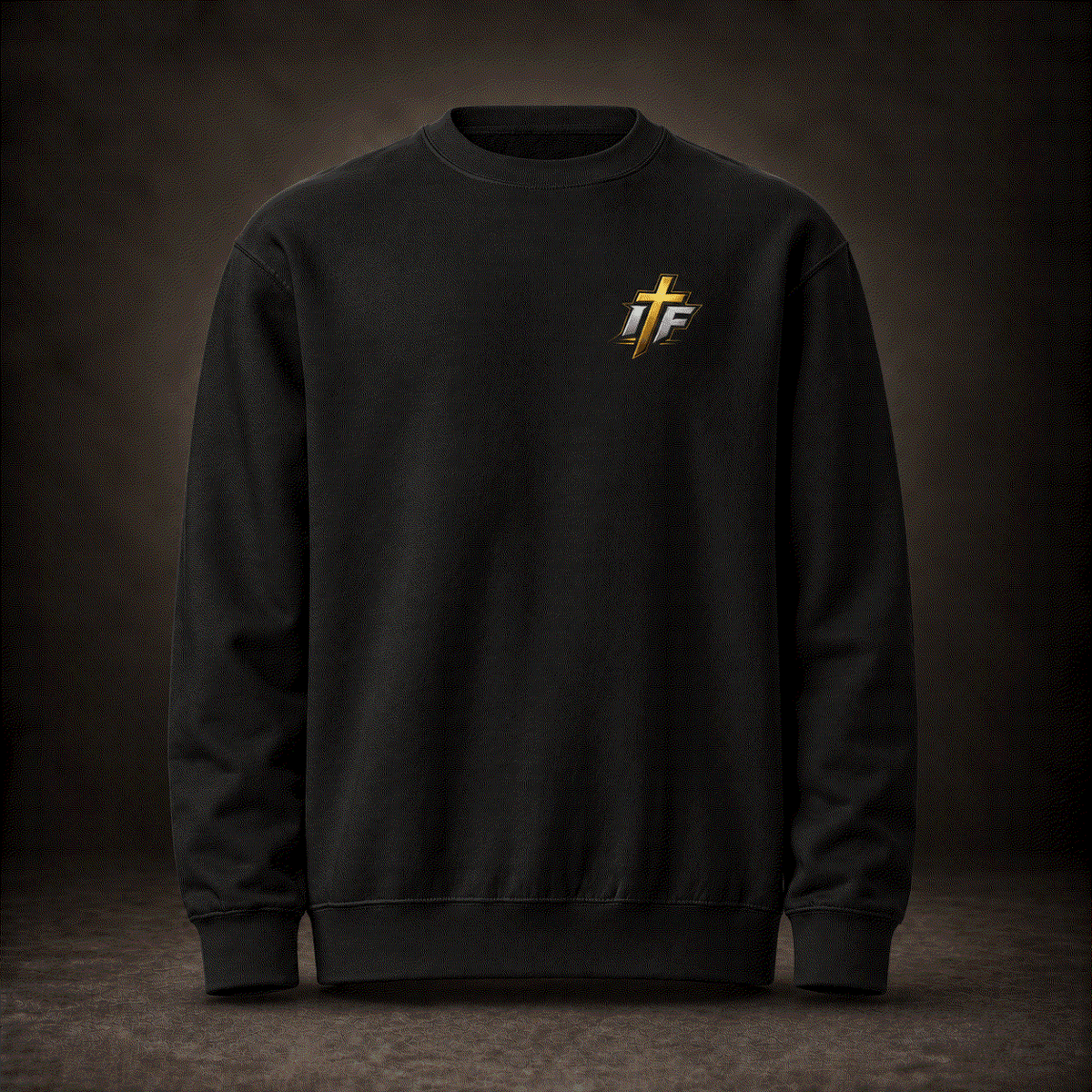 Front of black Faith Crewneck with small gold IFR cross logo on chest