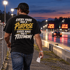 Man in Every Pass Has a Purpose Tee walking the drag strip at sunset holding a time slip