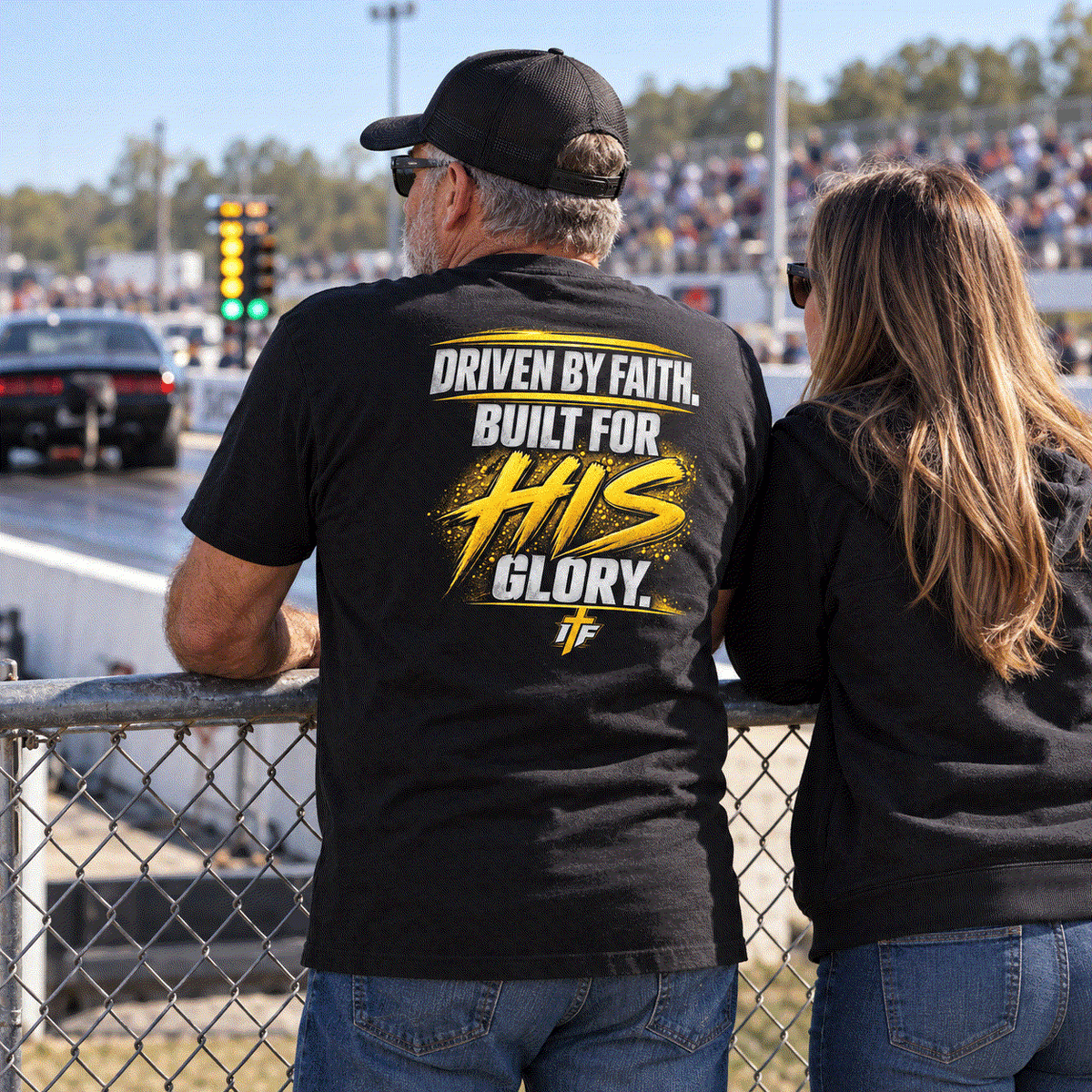 Father in Founding Supporter Tee and daughter watching races from the fence
