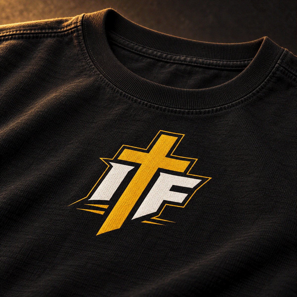 Close-up of gold IFR cross icon on black youth tee
