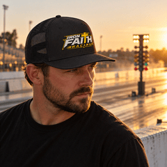 Crew chief in Iron Faith Racing trucker cap at the strip at sunset
