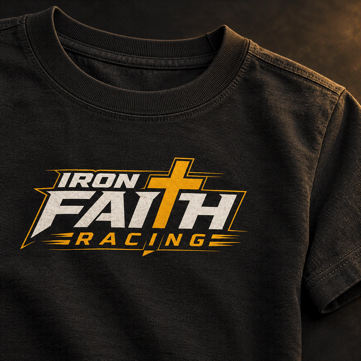 Close-up of Iron Faith Racing logo on youth tee chest