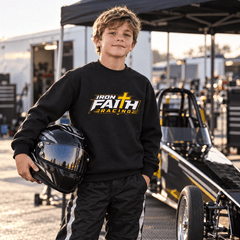 Junior racer in youth logo crewneck holding a helmet beside a junior dragster