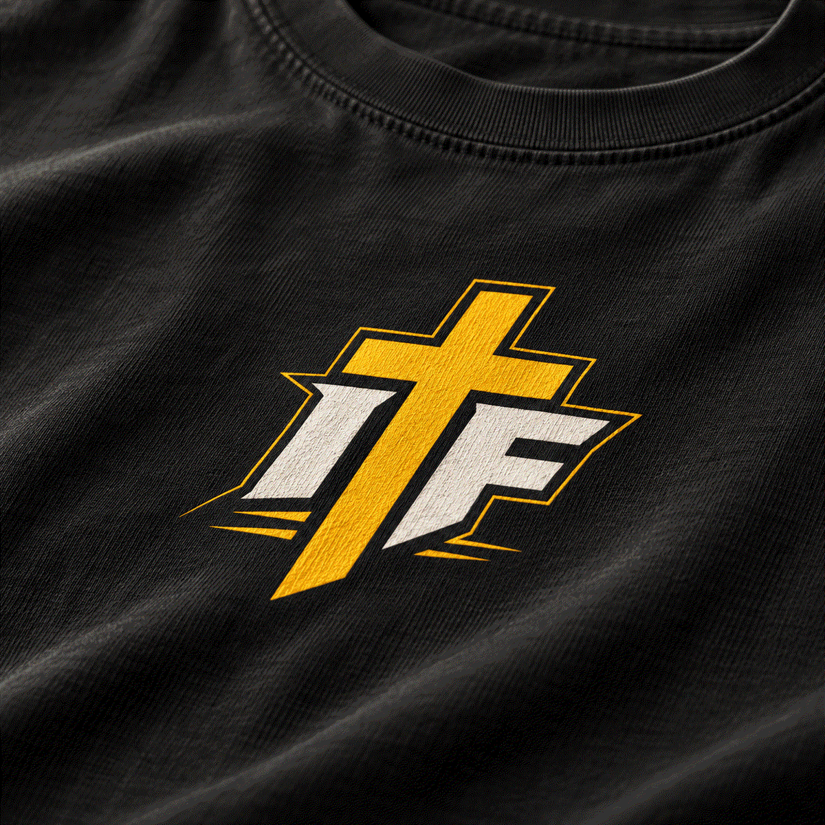 Close-up of gold IFR cross icon on washed black tee
