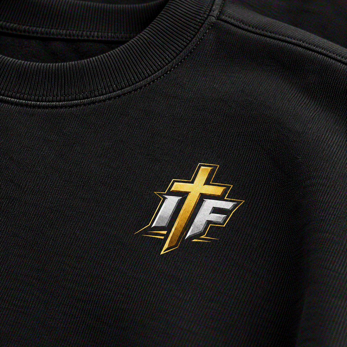 Close-up of gold and white IFR cross logo on Faith Crewneck chest