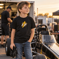 Boy in IFR youth icon tee standing by a junior dragster in the paddock
